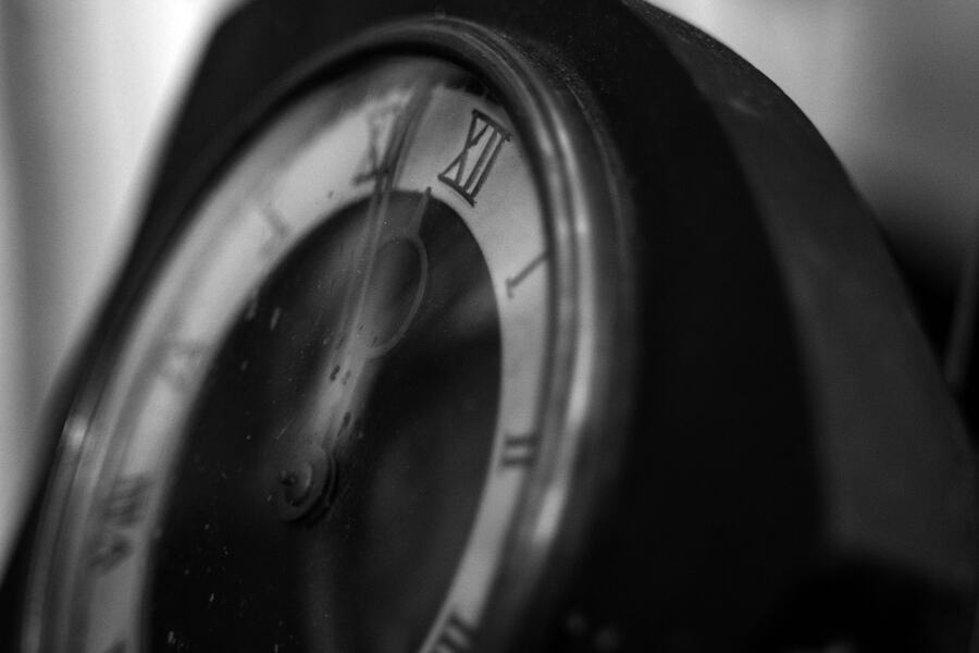 Close-up of an antique clock face, photographed in black and white