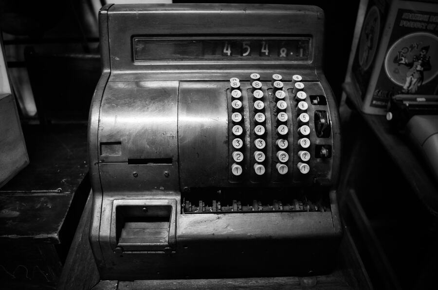 A vintage cash register, photographed in black and white